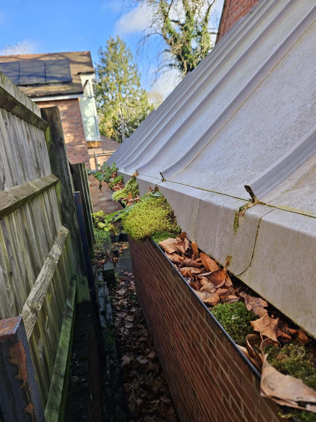 Gutter clearing in progress at a residential property in Leicester, Leicestershire